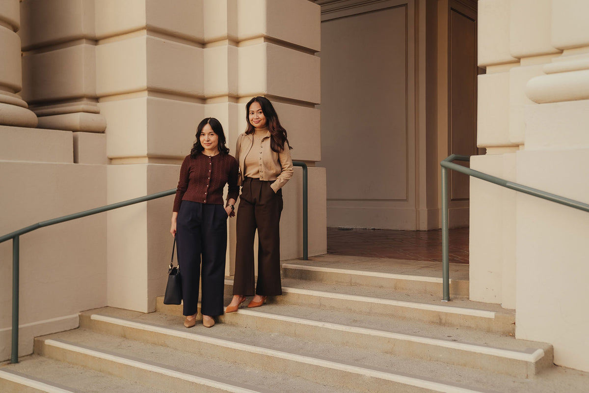 Petite dress pants in Espresso brown and Midnight navy blue, the founders standing together at Pasadena City Hall