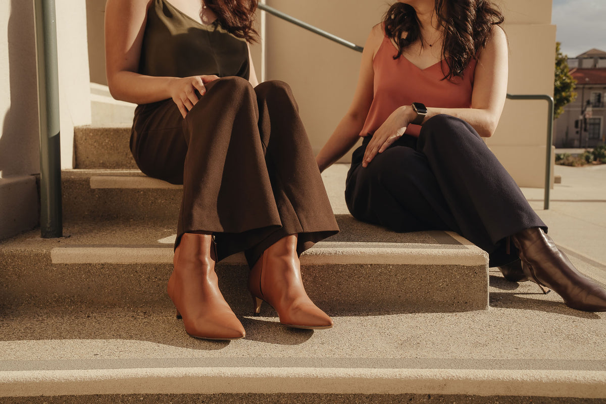 Petite dress pants in Espresso brown and Midnight navy blue, the founders seated on the steps at Pasadena City Hall