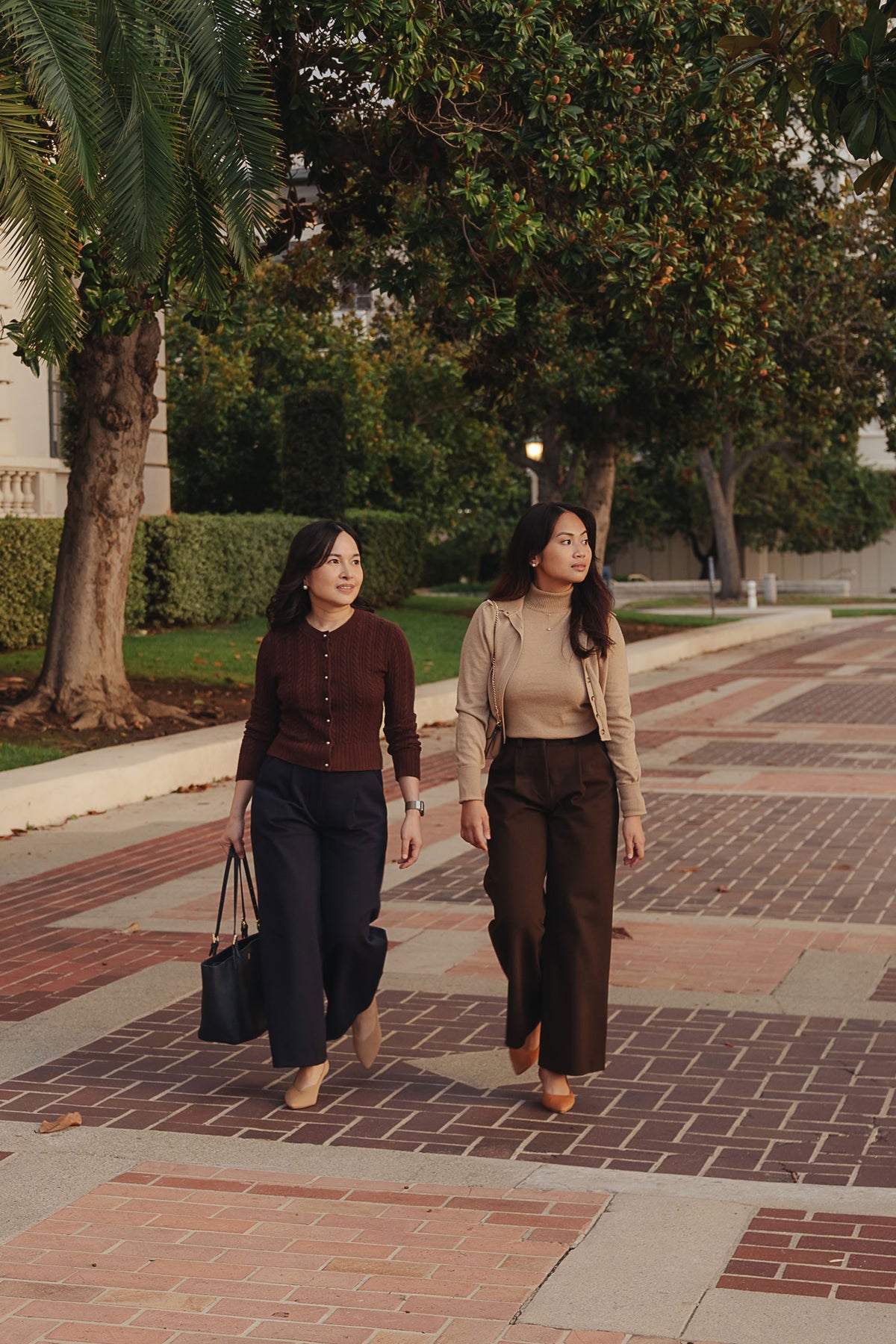 Petite dress pants in Espresso brown and Midnight navy blue, the founders walking across the plaza at Pasadena City Hall