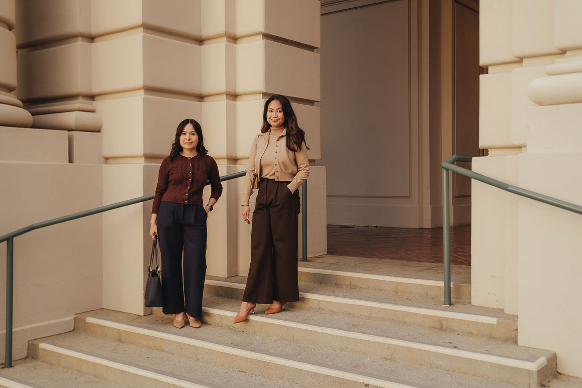 Petite dress pants in Espresso brown and Midnight navy blue, the founders standing together at Pasadena City Hall