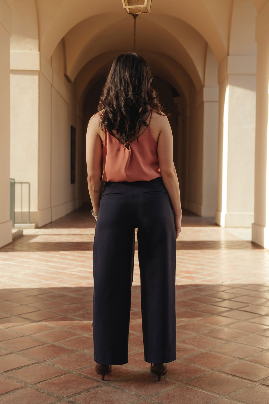 Petite dress pants in Midnight, a deep navy blue, back view showing the back pockets and clean drape, The Petite Standard