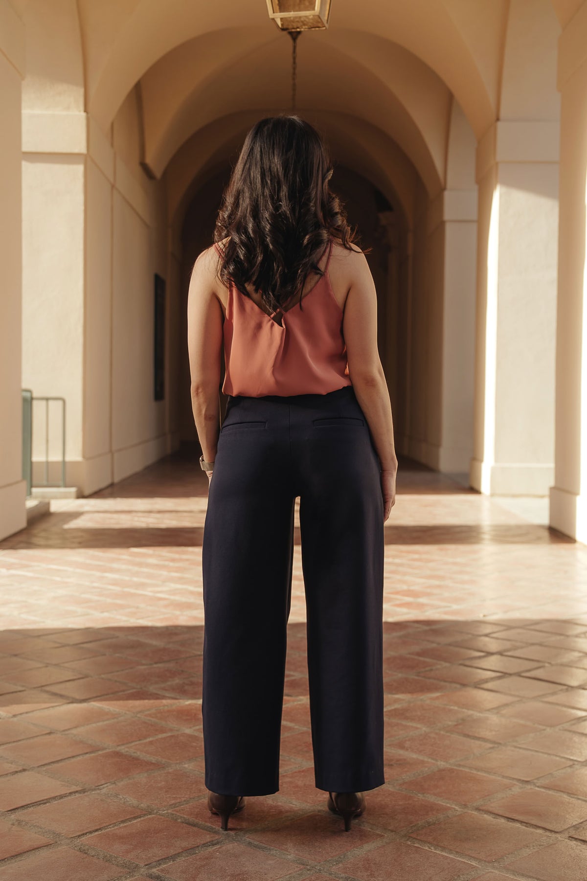 Petite dress pants in Midnight, a deep navy blue, back view showing the back pockets and clean drape, The Petite Standard