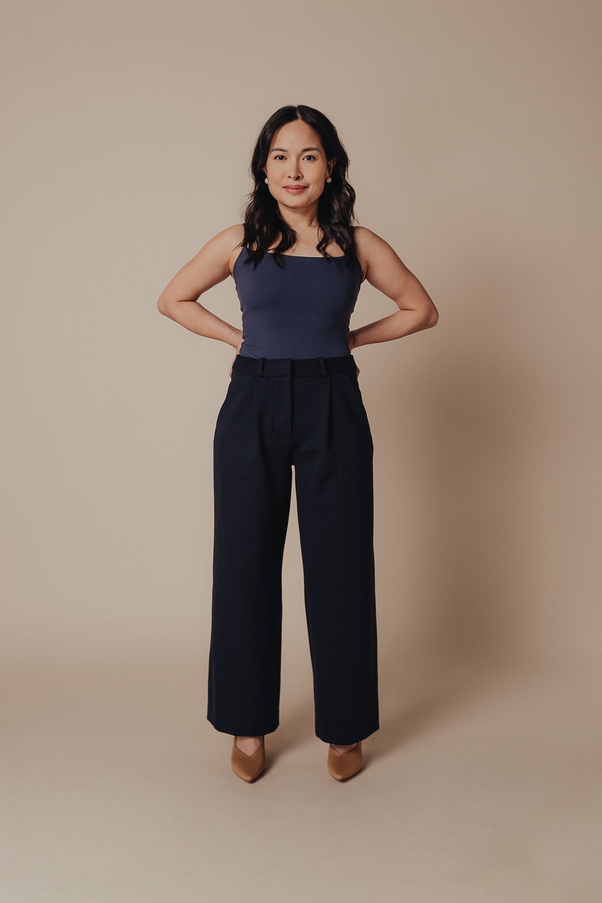 Petite dress pants in Midnight, a deep navy blue, front view in the studio, wide straight leg cut for petite proportions