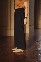 Petite dress pants in Midnight, a deep navy blue, hem and drape worn with flat loafers, The Petite Standard
