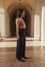 Petite dress pants in Midnight, a deep navy blue, side view showing the high rise and wide straight leg, The Petite Standard