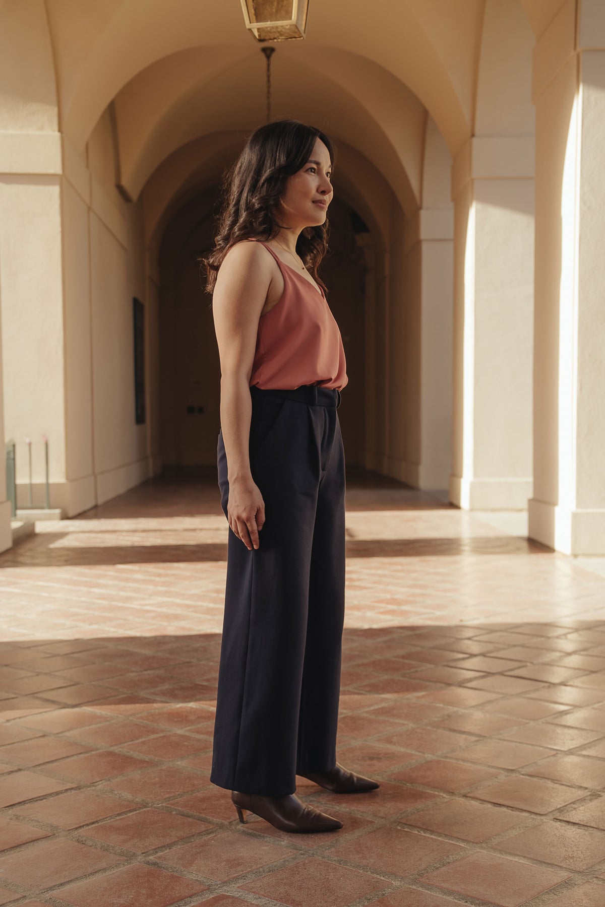 Petite dress pants in Midnight, a deep navy blue, side view showing the high rise and wide straight leg, The Petite Standard