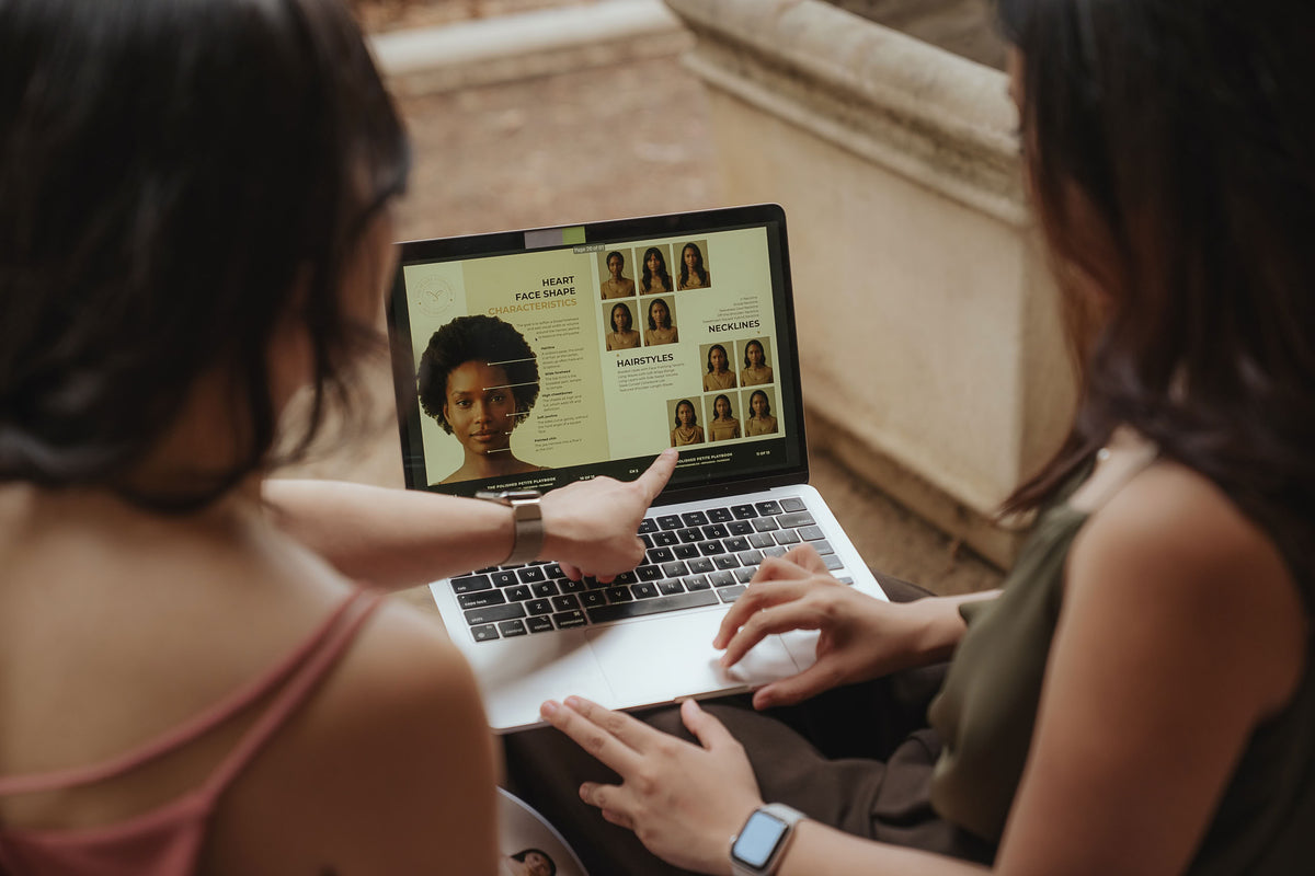 The Petite Standard founders reviewing the website on a laptop