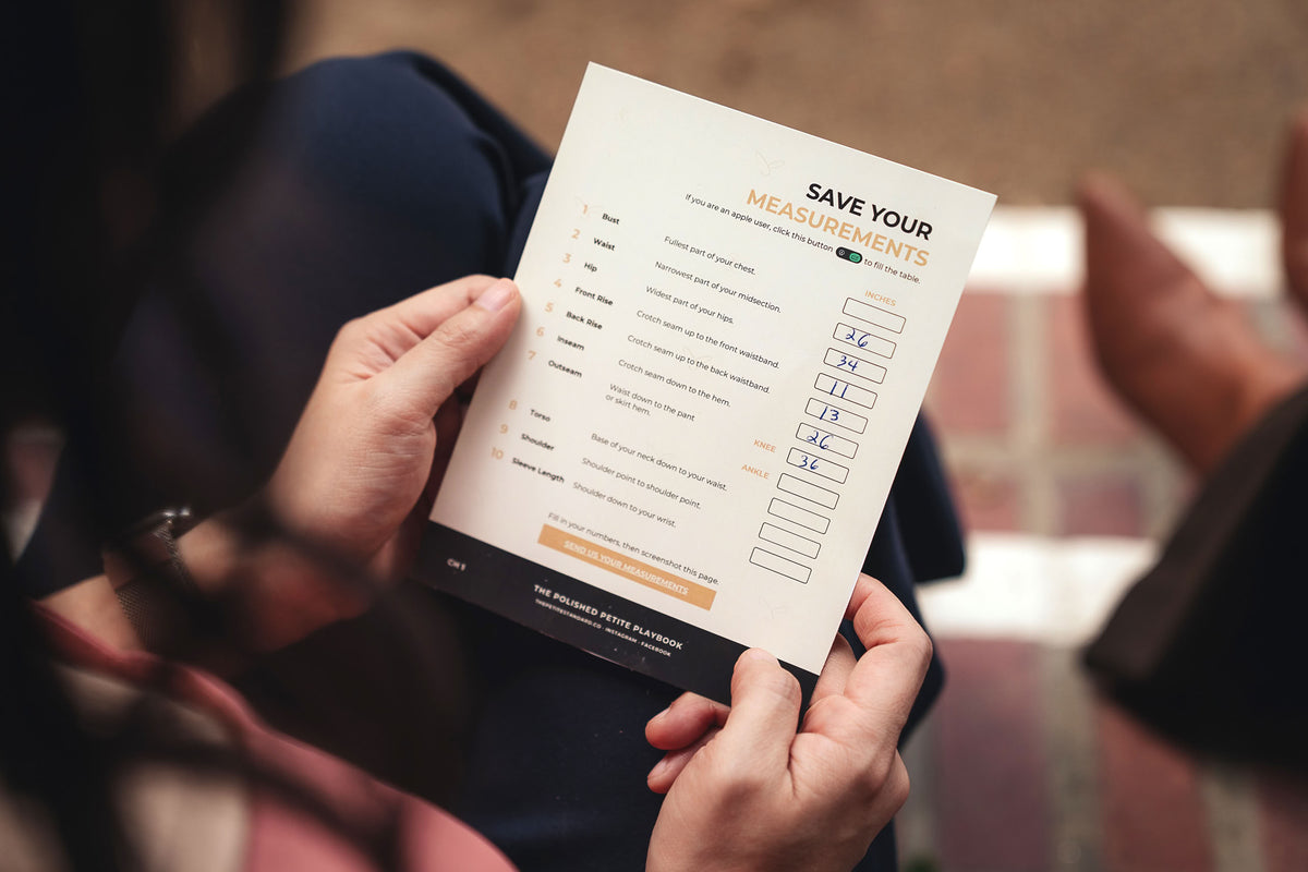 Holding the Save Your Measurements card from The Polished Petite Playbook, The Petite Standard