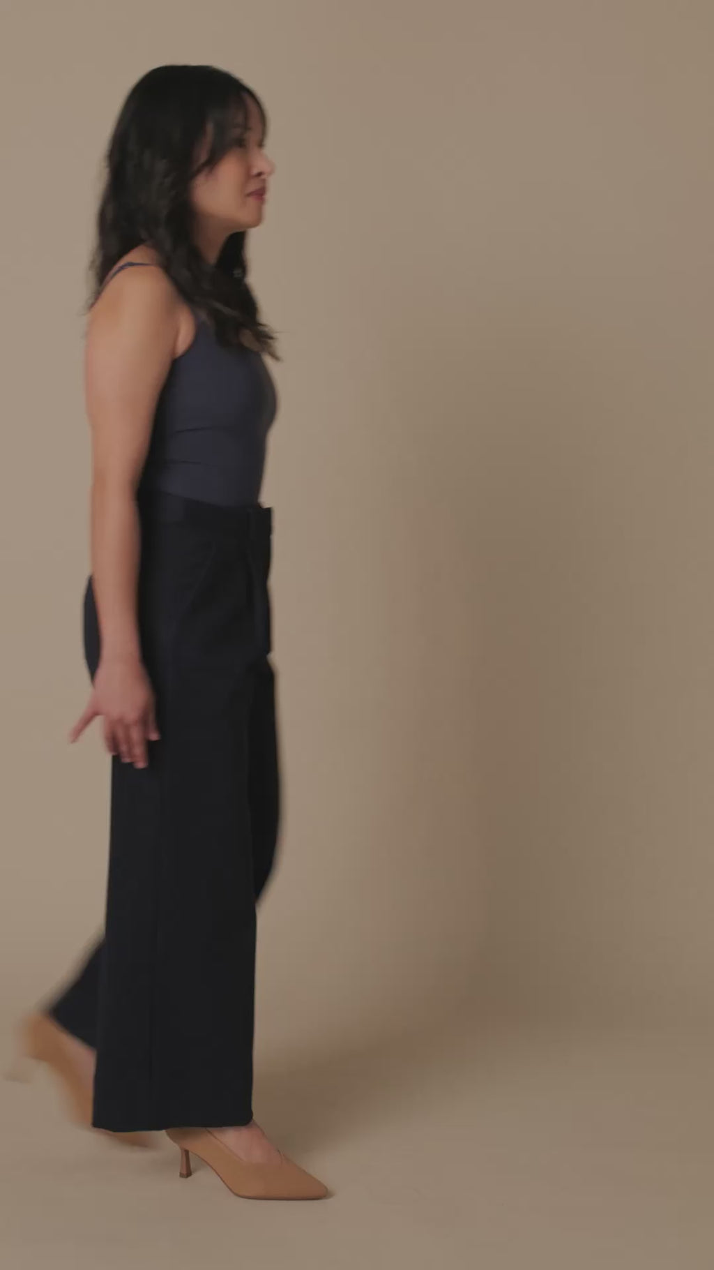 Petite dress pants in Midnight, a deep navy blue, studio turn showing the front, side with heels and back pockets